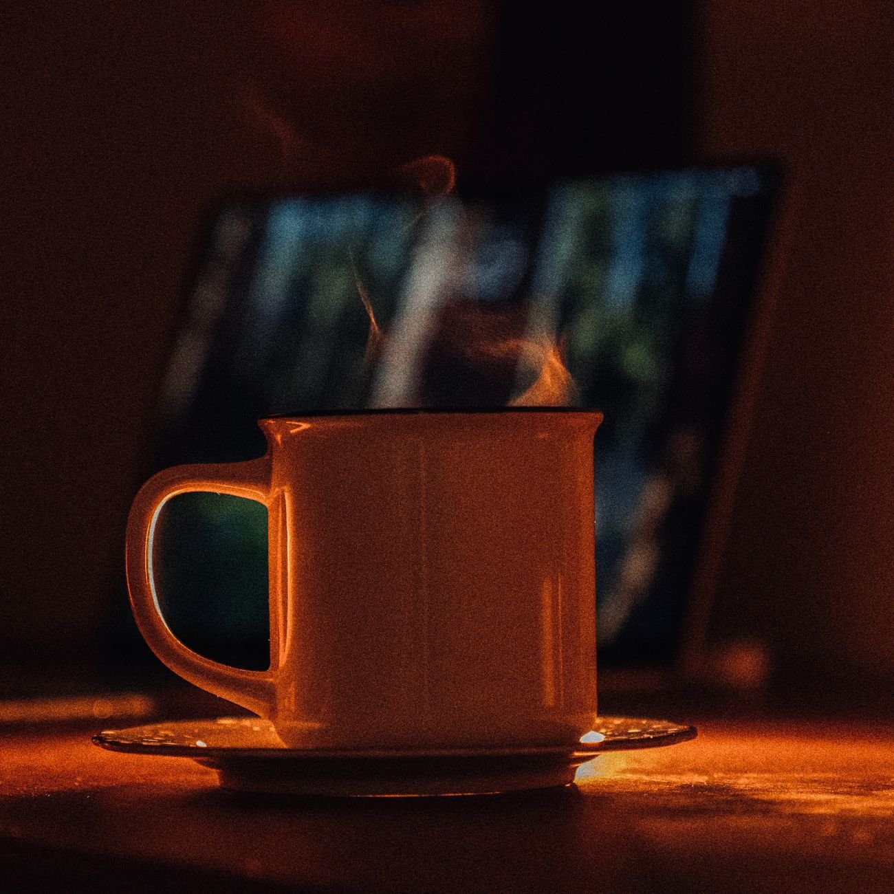 Warm ambiance with a steaming cup of tea on a cozy evening, perfect for relaxation.